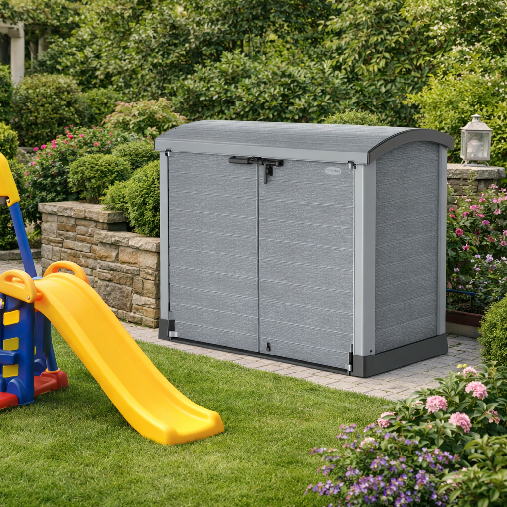 Duramax StoreAway 1200L grey storage shed in a garden with a yellow slide and greenery