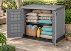 Duramax StoreAway 1200L Outdoor storage cabinet with open doors revealing cushions and a basket on a patio.