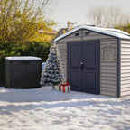 Duramax Storage sheds with snow on the ground, Christmas tree, and presents.