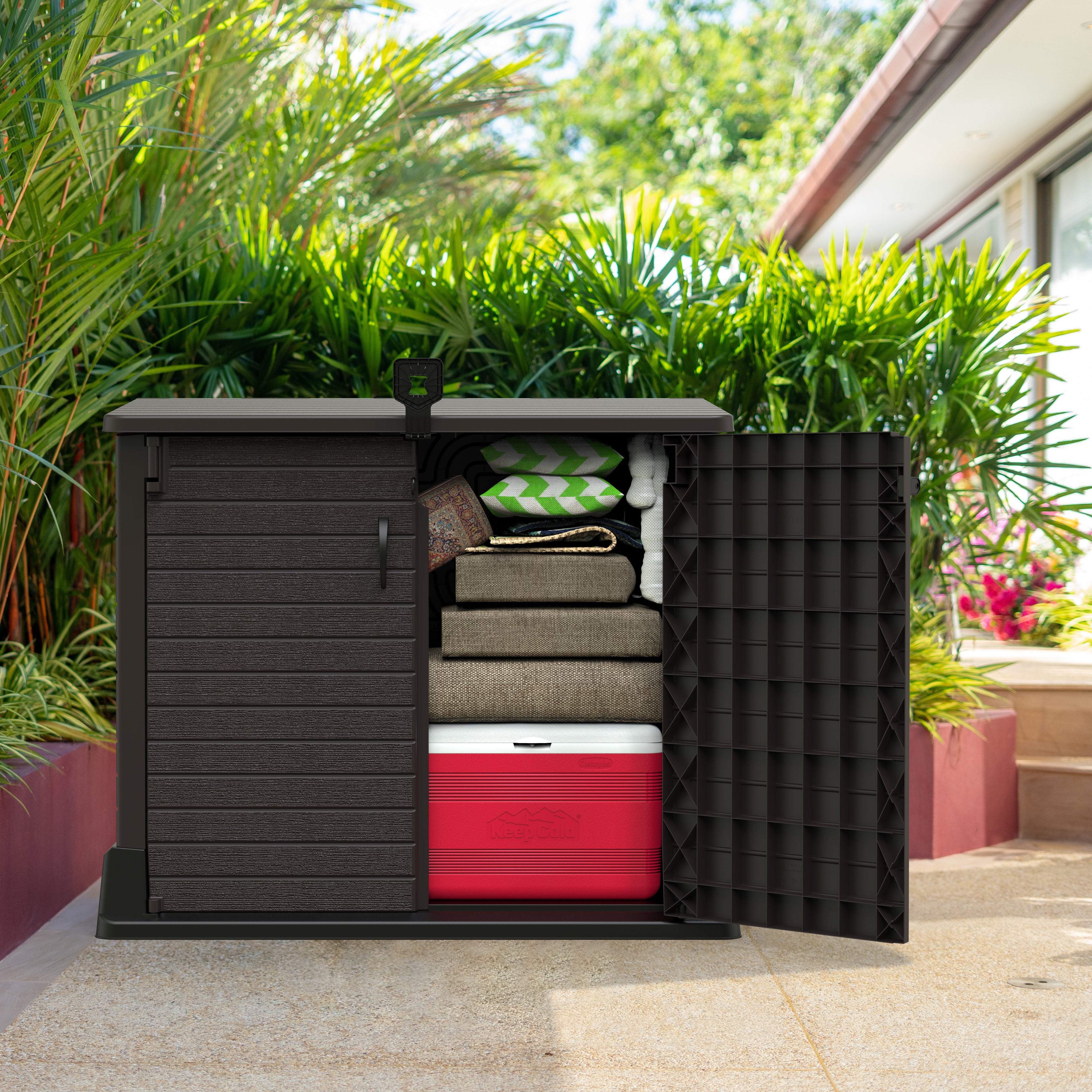 StoreAway 850L brown outdoor storage shed with open doors revealing items in a garden setting.