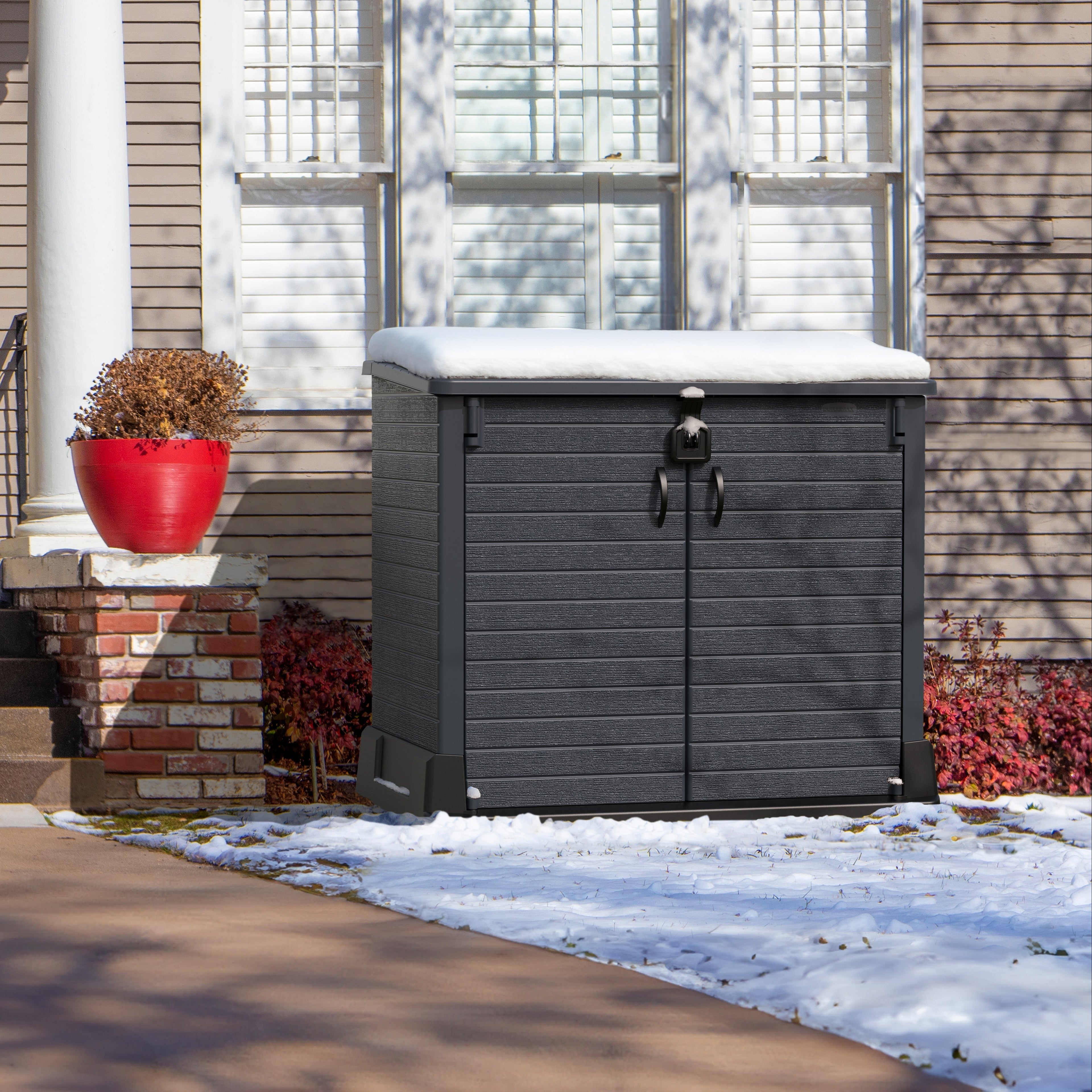 Duramax StoreAway 850L storage shed in front of a house with snow on the ground