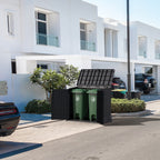 Duramax StoreAway8 50L wheelie garbage box with green trash cans inside, placed outdoors near a building.