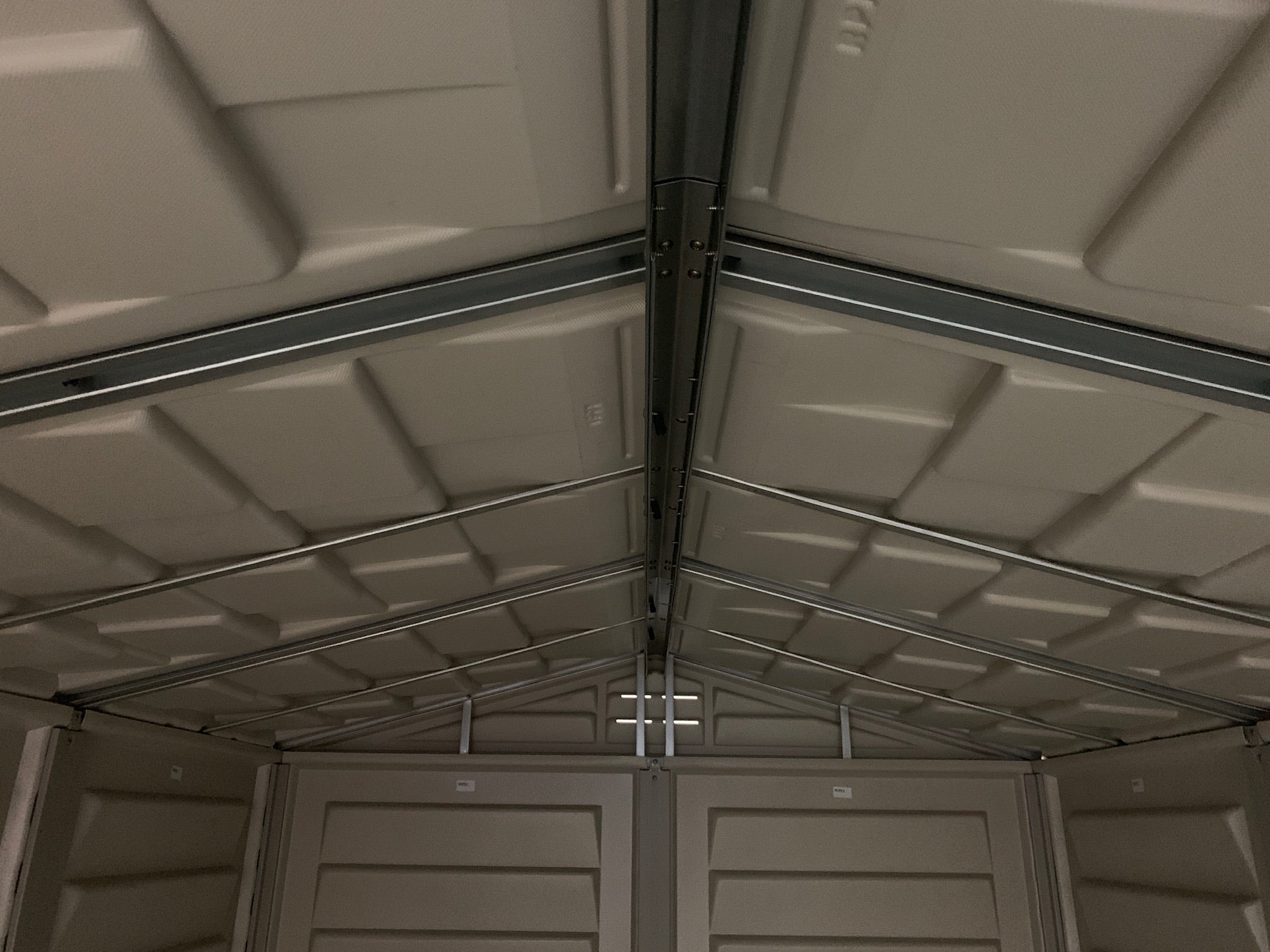 Close-up of the interior metal structure of the Duramax StoreMate PLUS  metal storage shed with open doors.