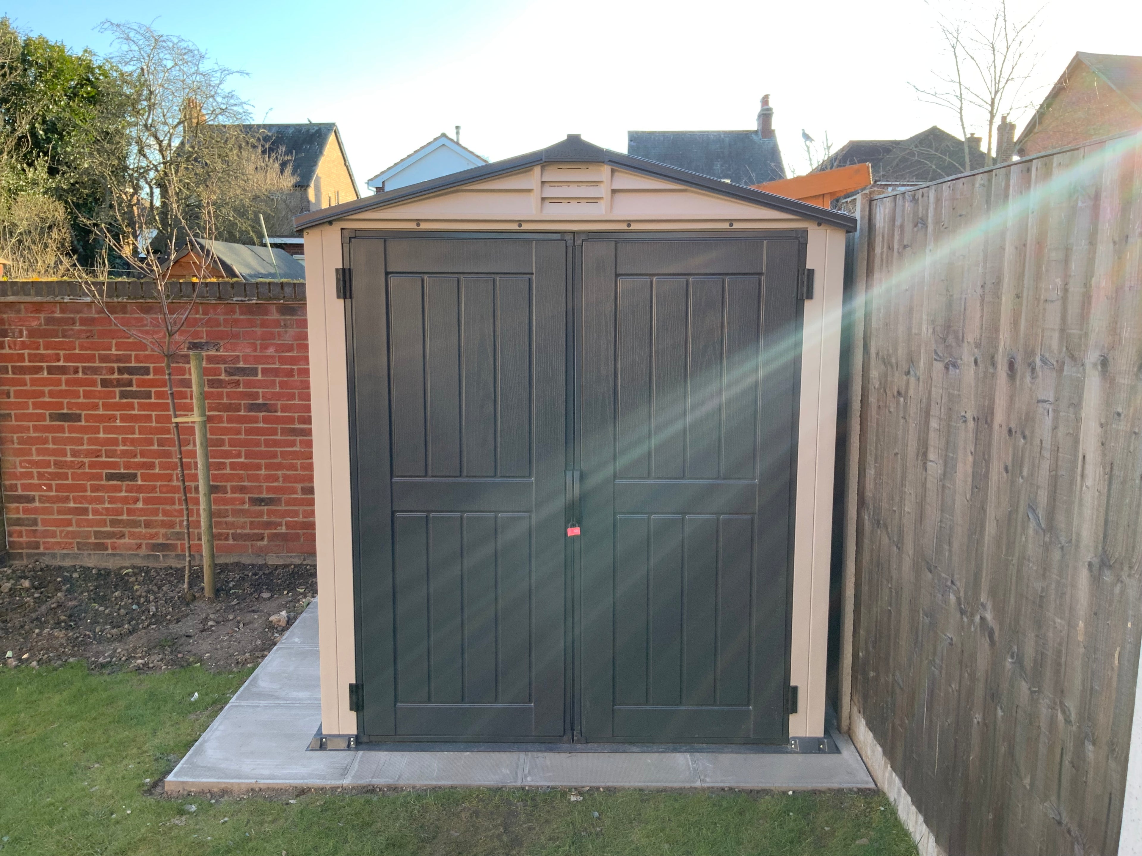 Garden shed with double doors in a backyard setting