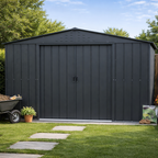 anthracite Duramax metal shed in a garden with a wheelbarrow and plants.