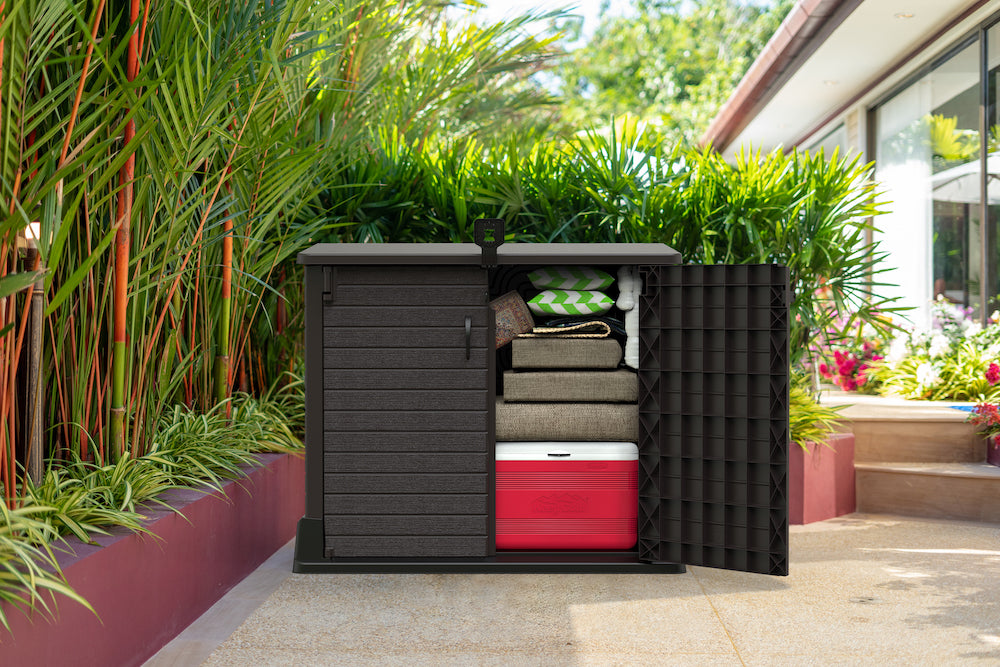 Brown plastic storage shed for ooutdoor use, ideal for storing folded furniture and any equipment, including wide double door entry for products.