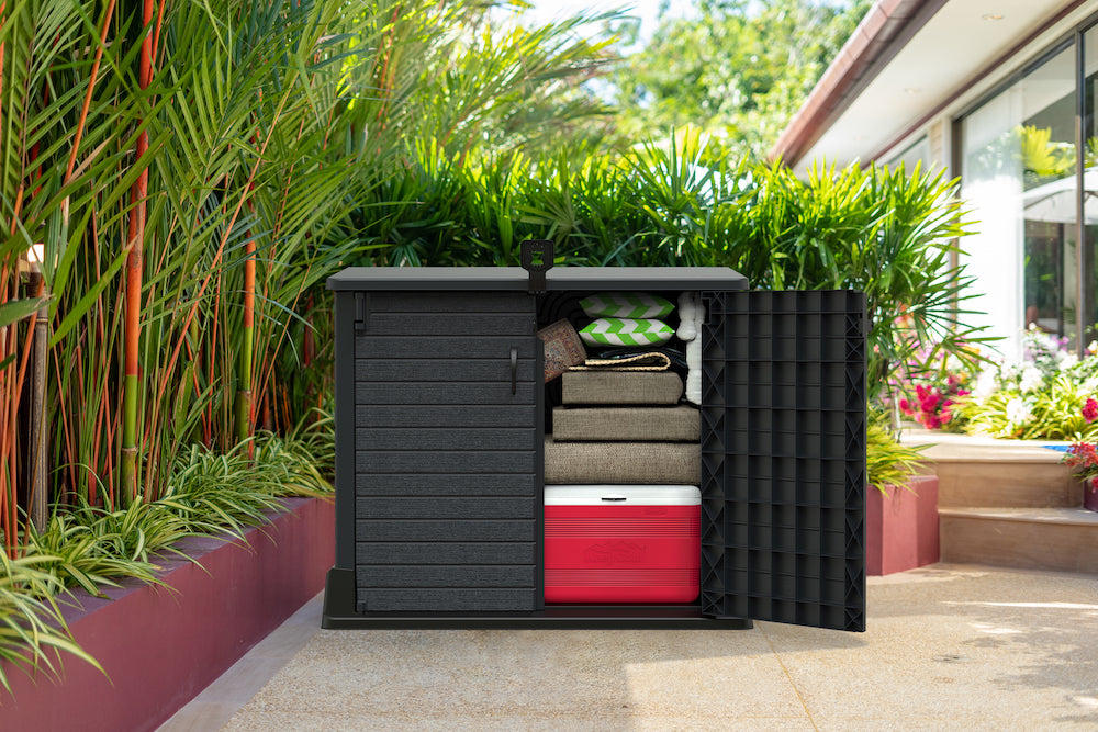 Dark grey plastic garden storage shed for garden, with top opening and wide doors.
