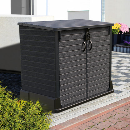 Dark grey plastic storage shed for outdoor use with wide double door entry for products.